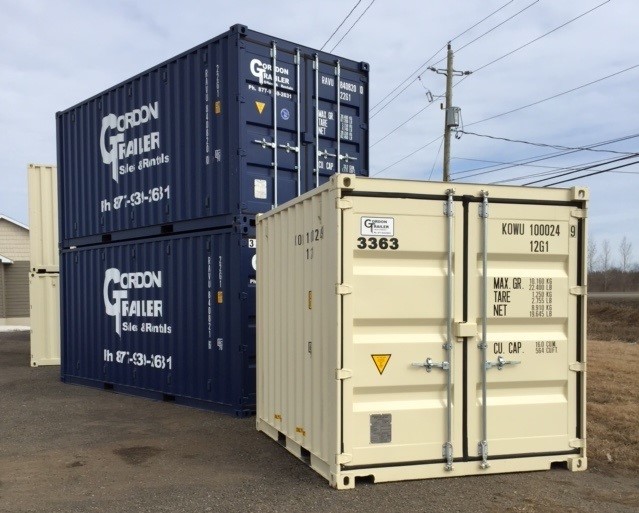 A couple of cargo containers are stacked on top of each other